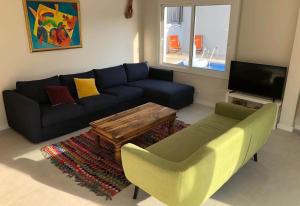 a living room with a couch and a table at Casa Nuestra in Begur
