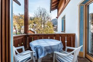 a table and two chairs on a balcony with a table at Cesa Valeria App Sonia in Ortisei