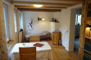 a room with a bed and a table in it at Ferienwohnung Teich 11, 126qm in Gütenbach +22 photos