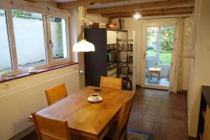 a dining room with a wooden table and chairs at Ferienwohnung Teich 11, 126qm in Gütenbach