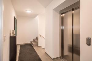 a hallway with a elevator and stairs in a building at Ferienwohnung Montfort in Langenargen