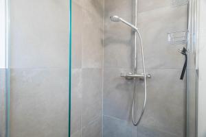 a shower with a glass door in a bathroom at Ferienwohnung Montfort in Langenargen +18 photos