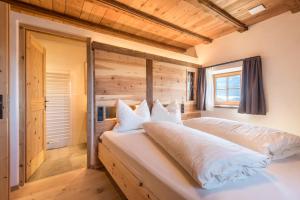 a bedroom with a large bed in a room at Hatzeshof Heustadel in Laion