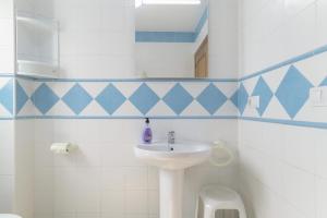 a bathroom with a sink and a toilet at Apartamento Perez Zara 7 in Conil de la Frontera +17 photos