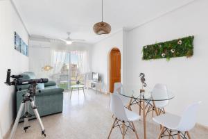 a living room with a camera and a table and chairs at Mistral Apartment La Manga in San Javier