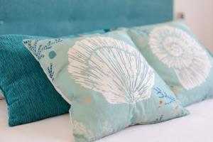three pillows sitting on top of a bed at Mistral Apartment La Manga in San Javier +16 photos