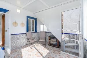 a living room with a staircase and a fireplace at Casa Carmen in Almuñécar