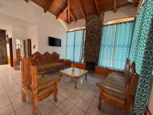 a living room with a couch and a table and chairs at Cabañas Monte Escondido in Mazamitla