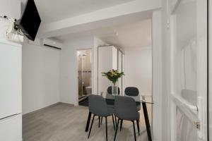 a dining room with a glass table and chairs at Loft Guanapay 2 in Los Cristianos