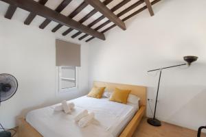 a bedroom with a bed with two pillows on it at Portblanc Front in Arenys de Mar