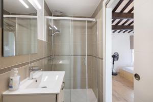 a bathroom with a sink and a shower at Portblanc Front in Arenys de Mar +18 photos