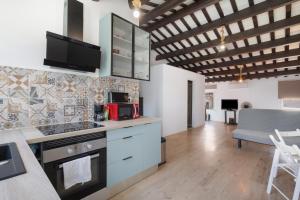 a kitchen with white cabinets and a counter top at Portblanc Front in Arenys de Mar
