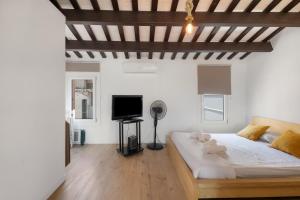 a bedroom with a bed and a flat screen tv at Portblanc Front in Arenys de Mar