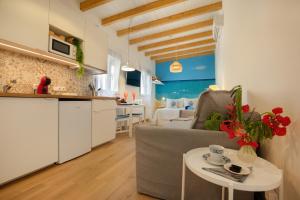 a kitchen and a living room with a couch and a table at Seguidilla Relax in Gran Tarajal