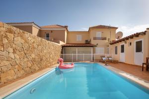 a swimming pool with a pink flamingo in a house at Seguidilla Relax in Gran Tarajal