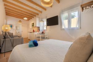 a bedroom with a bed and a living room at Seguidilla Relax in Gran Tarajal