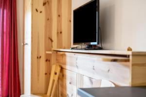 a television sitting on top of a wooden table at Lindenhof Apt 2 in Vandoies