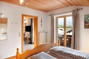 a living room with a couch and a window at Ferienwohnung Kramernest in Grainau