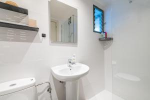 a white bathroom with a sink and a shower at Marsella in Port de Soller +17 photos