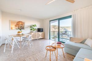 a living room with a couch and a table at Marsella in Port de Soller