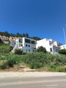 a white apartment building on the side of a road at Casa Vale do Paraíso in Sesimbra +24 photos