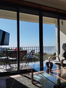 a living room with a view of the ocean at Casa Vale do Paraíso in Sesimbra