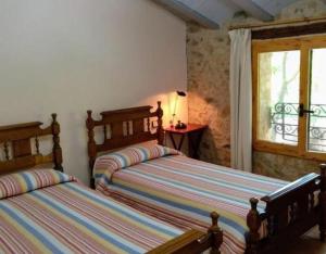 a bedroom with two beds and a window at Miramar in Montblanc +12 photos