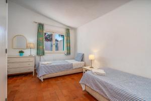 a bedroom with two beds and a dresser and a window at Ocean Villa Algarve in Alvor +37 photos