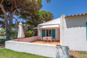 a patio with a table and an umbrella at Ocean Villa Algarve in Alvor