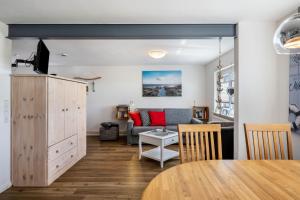 a living room with a couch and a table at Huus achtern Diek in Nordstrand