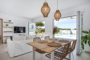 a living room with a table and a couch at Casa Robert in Conil de la Frontera