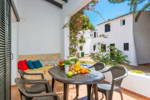 a patio with a table and chairs on a balcony at Cala Serena Beach 1 in Felanitx