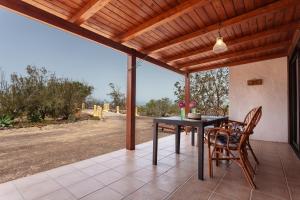 a patio with a table and chairs on a patio at Oasis en Cotillo in Roque