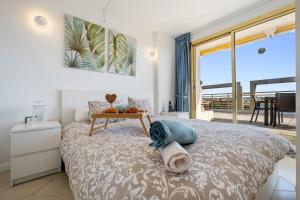 a bedroom with a bed with a table on it at Salou apartment beach in Salou +22 photos