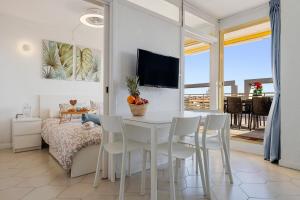 a living room with a table and chairs and a bedroom at Salou apartment beach in Salou
