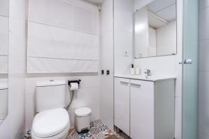 a white bathroom with a toilet and a sink at Piso Garaje Gratis Granada in Granada +22 photos