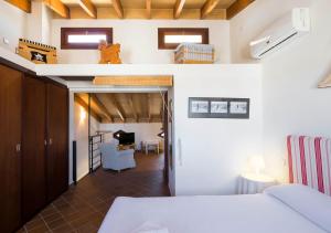 a room with a bed and a living room at Sa Caseta in Felanitx