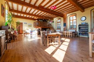 a large living room with wooden floors and a wooden ceiling at La Chastanha in Saint-Symphorien-de-Mahun