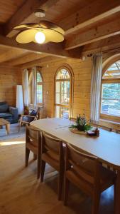 a dining room with a large wooden table and chairs at Bieszczadzki Rewir in Wetlina
