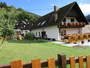 a white house with a yard with a playground at Ferienwohnung Faller in Elzach +5 photos