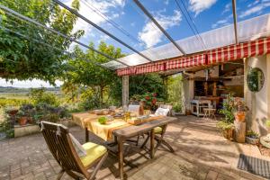 an outdoor patio with a wooden table and chairs at Petite Suite Douillette - Suite in Saint-Pargoire