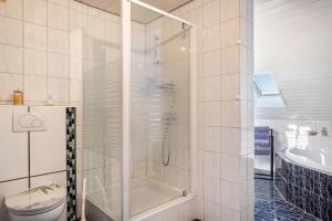 a bathroom with a shower and a toilet and a sink at fewo-wosink in Bad Krozingen +19 photos