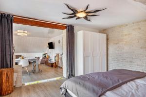 a bedroom with a bed and a brick wall at fewo-wosink in Bad Krozingen