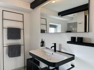 a bathroom with a sink and a mirror at Loft32 in Nordstrand +14 photos