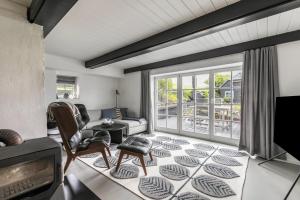 a living room with a couch and a tv at Loft32 in Nordstrand