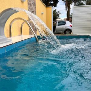 a water fountain in a swimming pool at Terramar condominium! Coral beach! in Tamoios