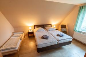 a bedroom with a bed and two chairs in it at Ferienhaus Ferienhof Behnke in Heringsdorf
