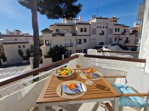 a table with a bowl of fruit on a balcony at Apartment Atalaya Rio Verde by Interhome in Marbella