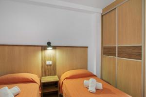 two beds in a room with towels on them at Estudio Yumbo Playa in San Bartolomé +17 photos