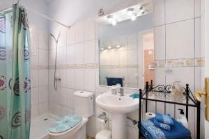 a bathroom with a toilet a sink and a shower at Atico Las Arenas in Arico +14 photos